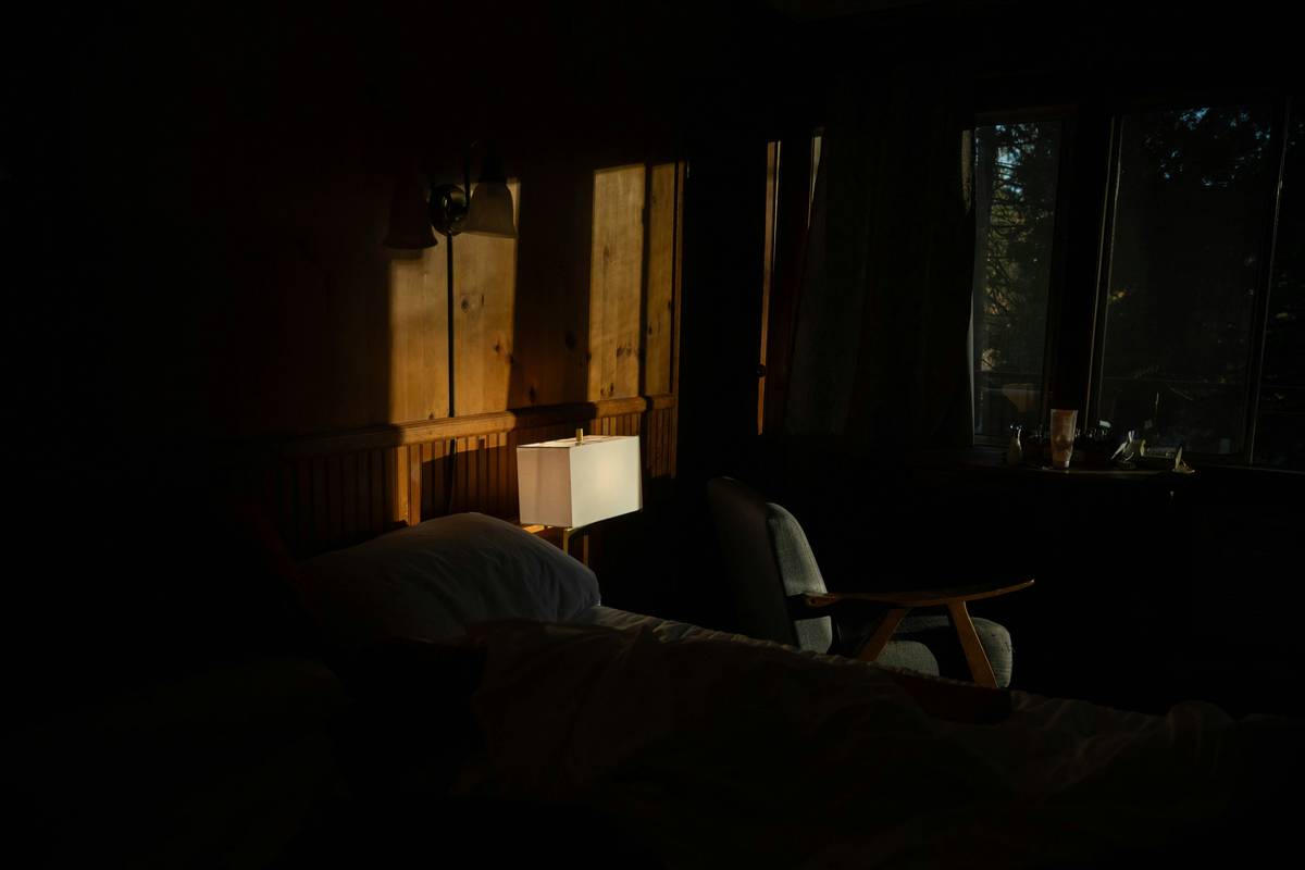 relaxation mood smart lighting system home with amber-hued LED strips illuminating a cozy bedroom corner